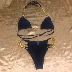 Two bathing suits never worn; 1 black & 1 purple